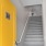 a staircase with yellow doors