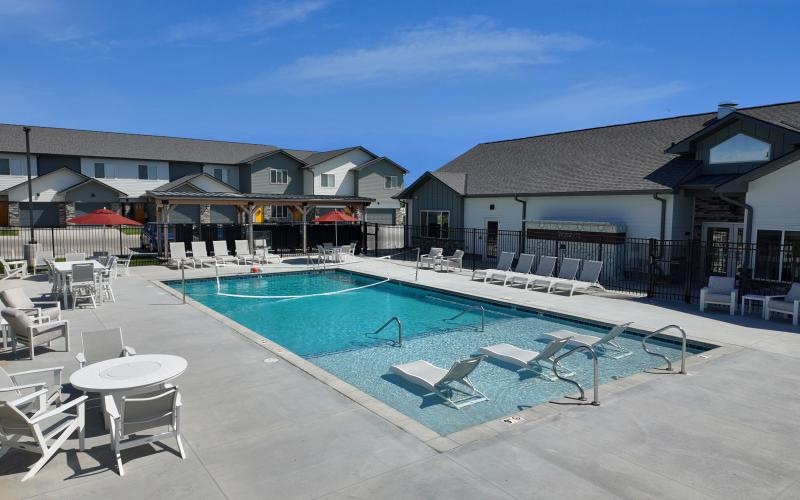 a swimming pool with chairs around it