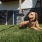 a dog laying in grass