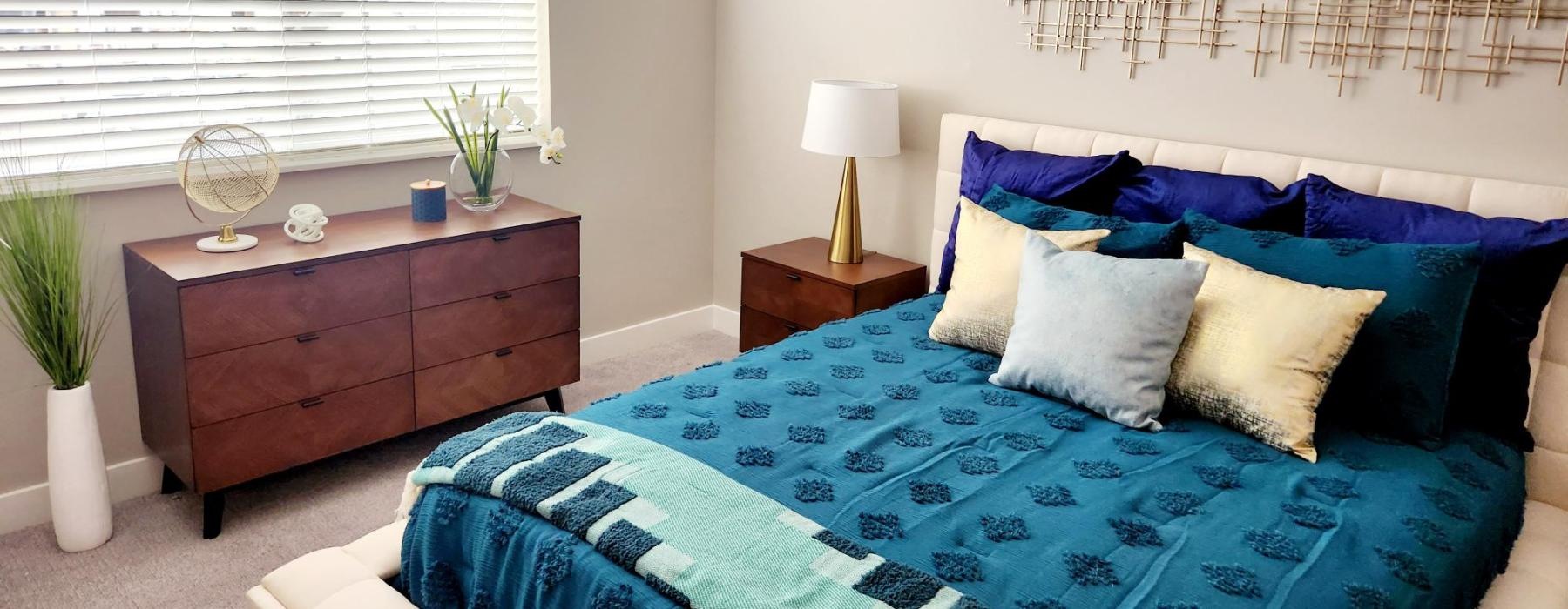 a bed with a blue and white comforter