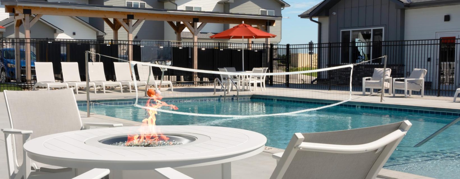 firepit and courtyard area beside the pool