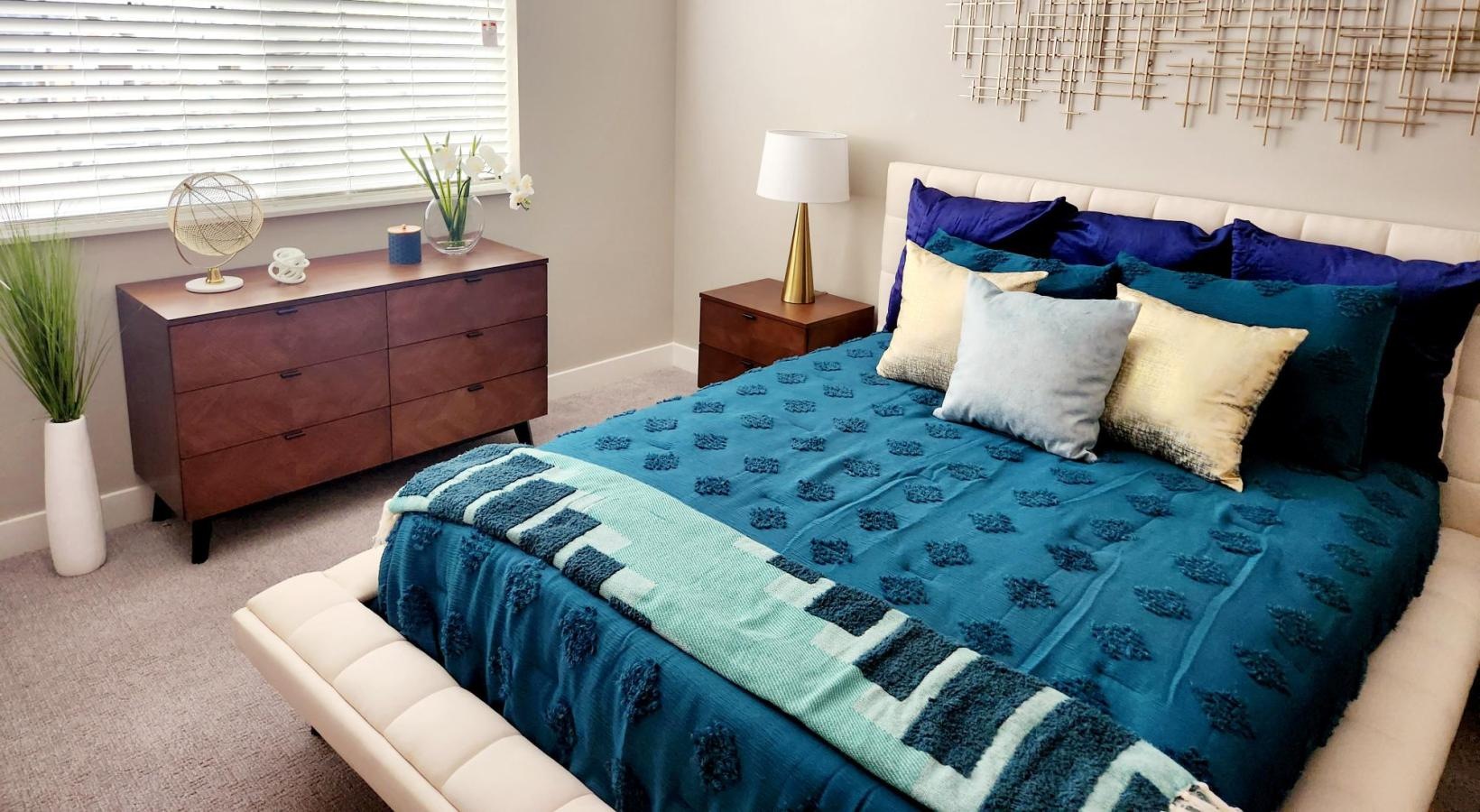 Generous bedroom offerings to fit every family a bed with a blue and white comforter